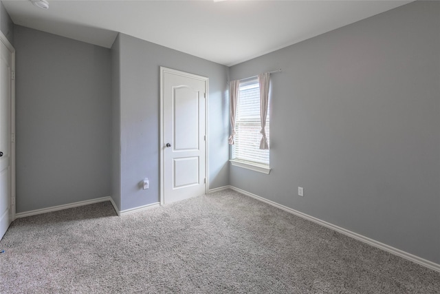 empty room with carpet flooring and baseboards