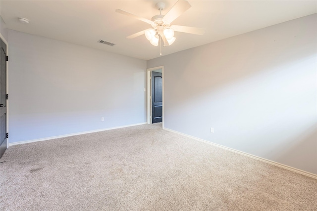 unfurnished room featuring a ceiling fan, carpet, visible vents, and baseboards