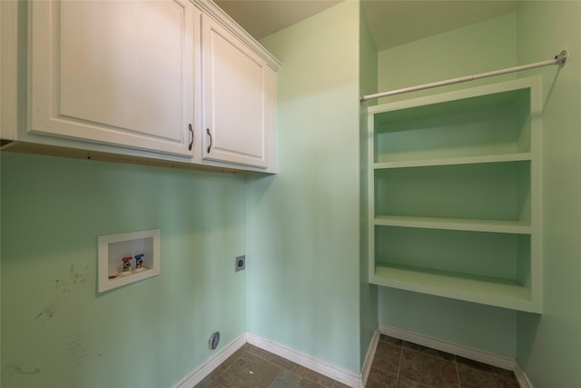 laundry area with baseboards, hookup for a washing machine, cabinet space, and hookup for an electric dryer