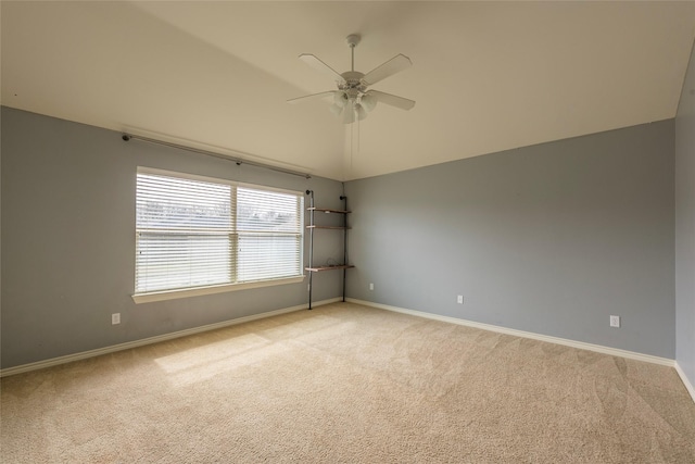 unfurnished room featuring ceiling fan, baseboards, vaulted ceiling, and light colored carpet