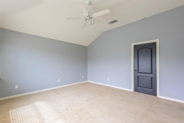 unfurnished room with lofted ceiling, light carpet, visible vents, and a ceiling fan