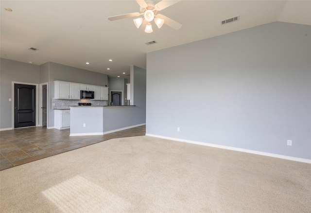 unfurnished living room featuring carpet floors, visible vents, and baseboards