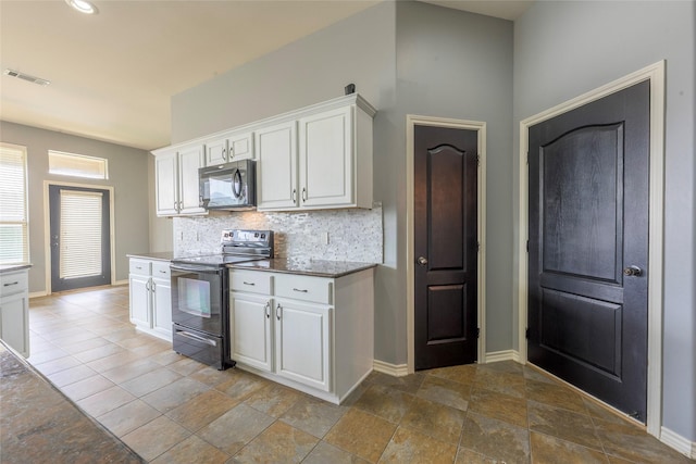 kitchen featuring visible vents, electric range, and white cabinetry