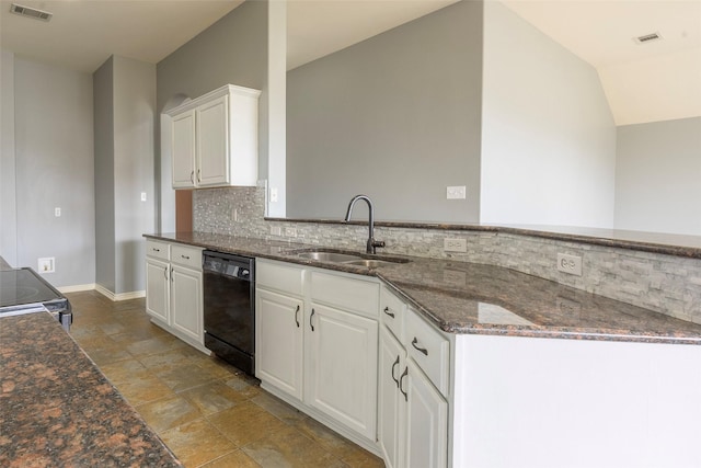 kitchen featuring visible vents, white cabinets, dishwasher, dark stone counters, and a sink