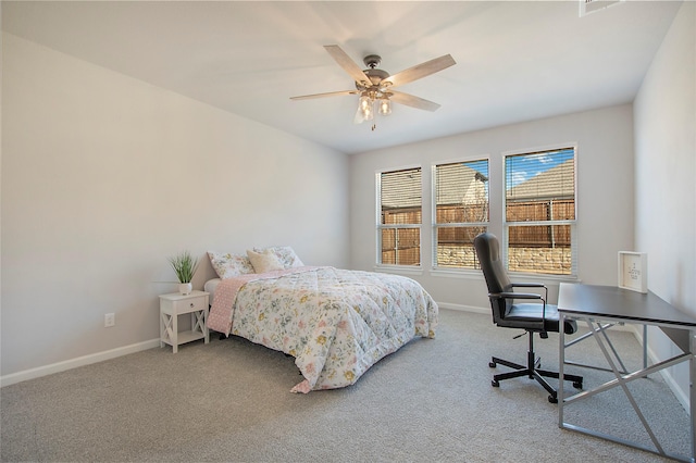 carpeted bedroom with ceiling fan and baseboards