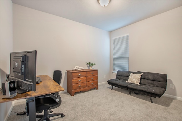 home office with baseboards and light colored carpet