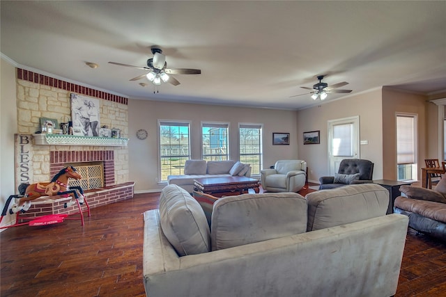 living room featuring ceiling fan, a large fireplace, baseboards, ornamental molding, and dark wood-style floors