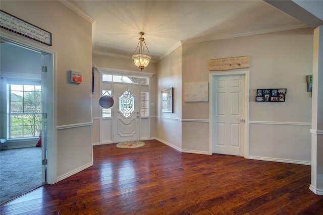 entrance foyer with baseboards, a healthy amount of sunlight, dark wood finished floors, and crown molding