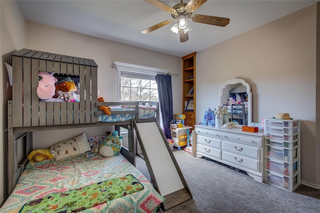 bedroom featuring ceiling fan and dark carpet