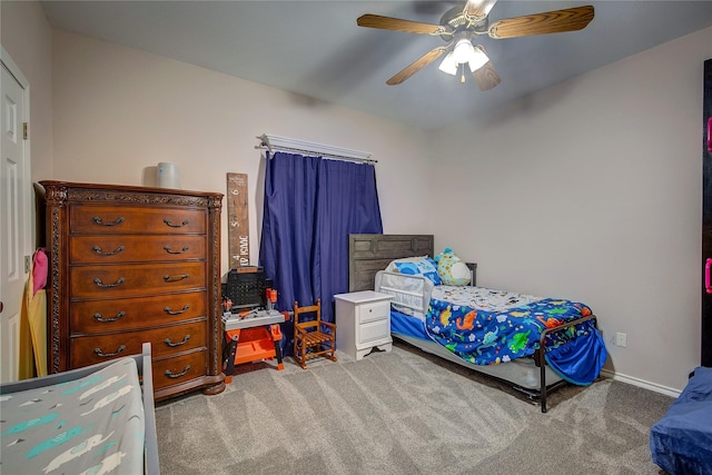 bedroom featuring baseboards, a ceiling fan, and light colored carpet