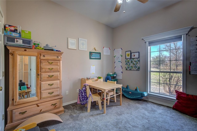 carpeted home office with a healthy amount of sunlight, ceiling fan, and baseboards