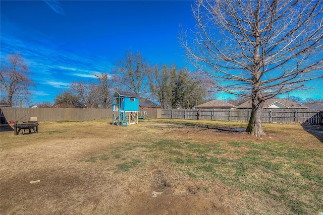 view of yard featuring a playground and a fenced backyard