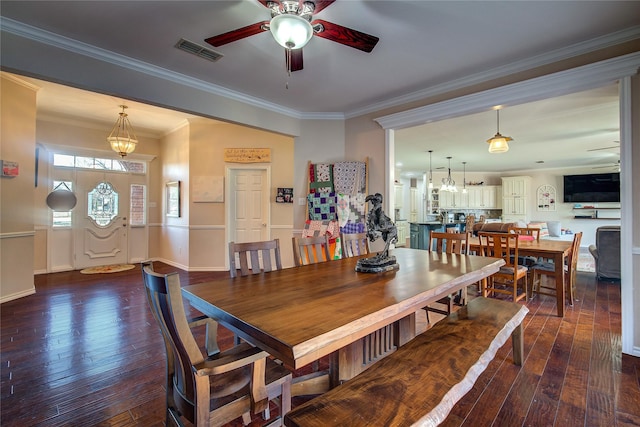 dining area with ceiling fan, dark wood-type flooring, visible vents, and crown molding