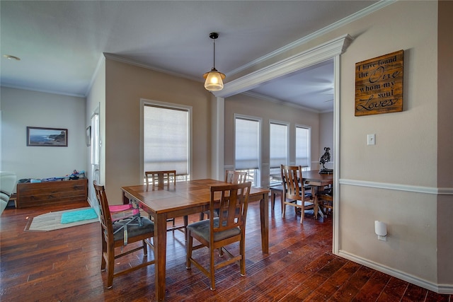 dining area featuring dark wood-style floors, crown molding, and baseboards