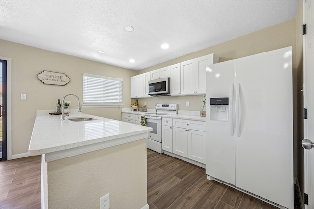 kitchen with dark wood-style floors, white cabinets, a sink, a textured ceiling, and white appliances