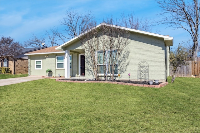 single story home featuring brick siding, a front yard, and fence