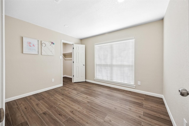 unfurnished room with wood finished floors and baseboards