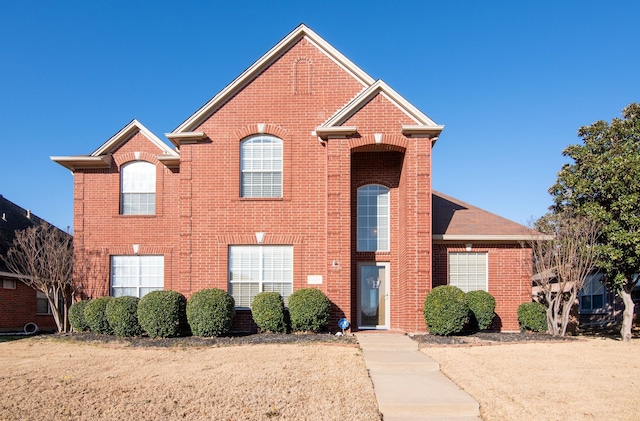 traditional-style house featuring brick siding