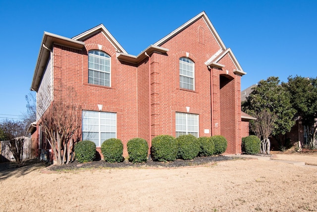 view of side of home with brick siding