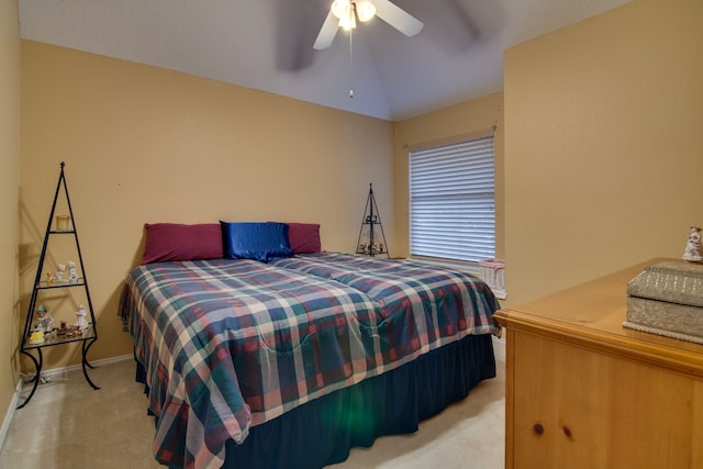 bedroom with light carpet, vaulted ceiling, a ceiling fan, and baseboards