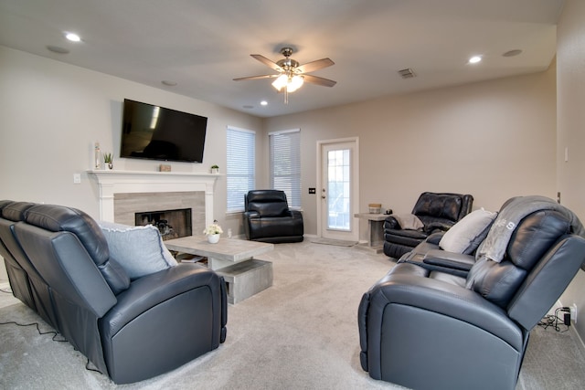 living room featuring ceiling fan, recessed lighting, light carpet, a fireplace, and visible vents