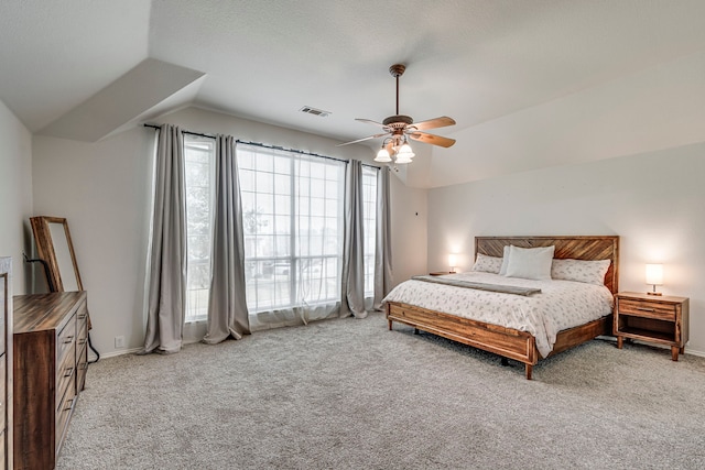 bedroom featuring ceiling fan, baseboards, vaulted ceiling, and light colored carpet