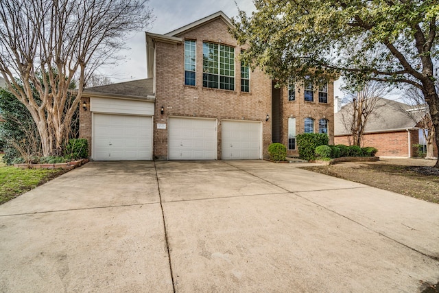 view of front of house with concrete driveway, brick siding, and an attached garage