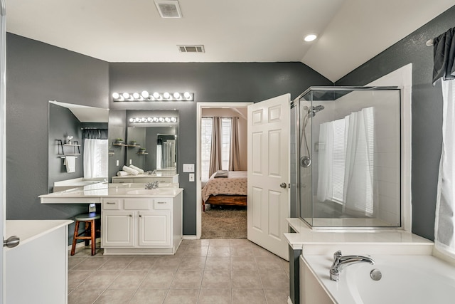 ensuite bathroom featuring lofted ceiling, tile patterned flooring, vanity, visible vents, and a stall shower