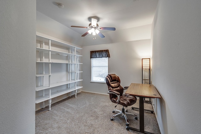 carpeted office with a ceiling fan and baseboards