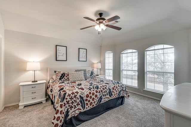 bedroom featuring light colored carpet, ceiling fan, and baseboards