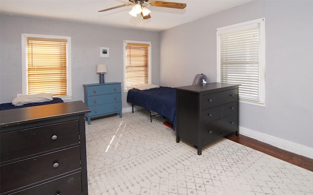 bedroom featuring a ceiling fan and baseboards