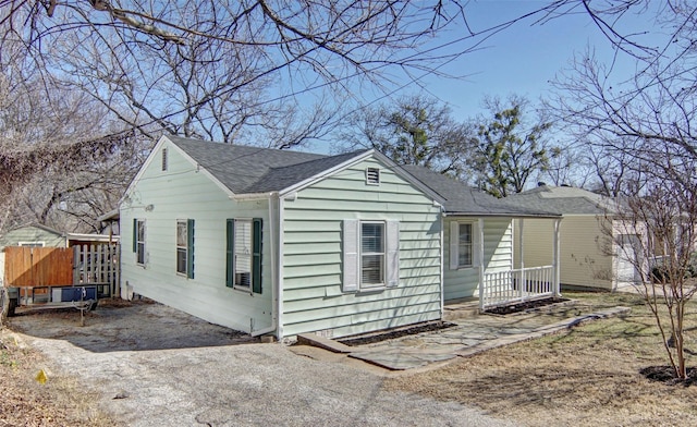 view of front of property with a porch and roof with shingles