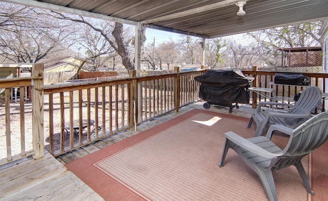 wooden deck featuring a fenced backyard and grilling area