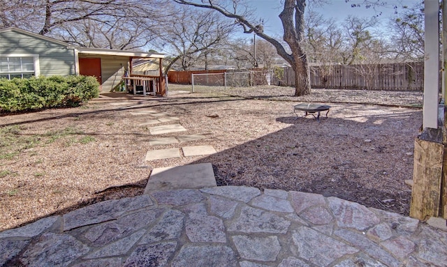 view of yard featuring a fire pit and a fenced backyard