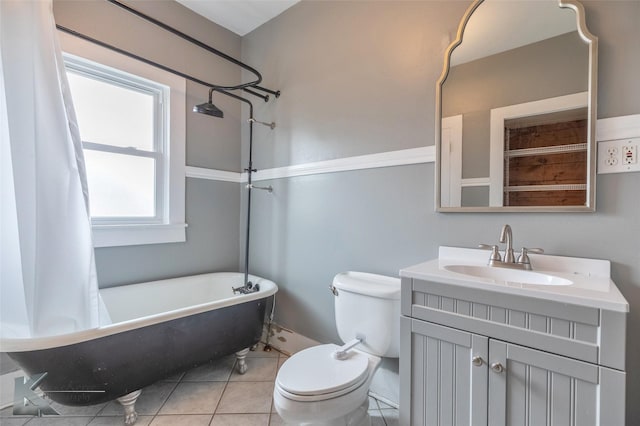 full bath featuring toilet, vanity, and tile patterned floors