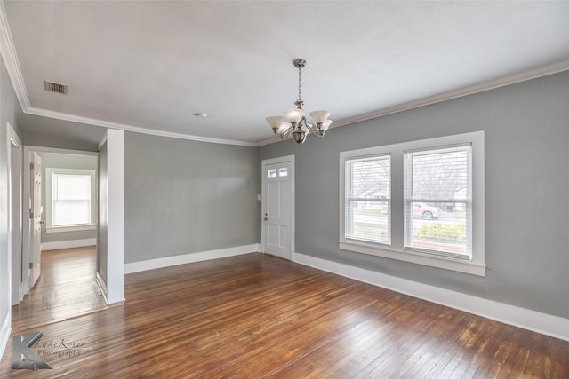 interior space with baseboards, visible vents, dark wood-type flooring, crown molding, and a chandelier