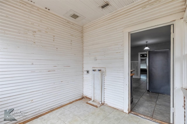 unfurnished room with light tile patterned floors