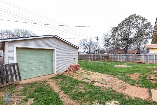 garage with driveway and fence