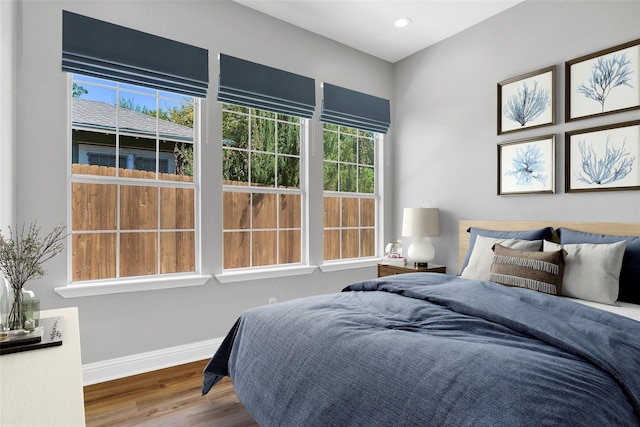 bedroom featuring recessed lighting, wood finished floors, and baseboards