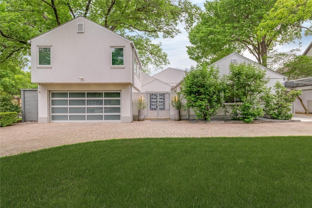 6005 Northwood Rd, Dallas, TX 75225 - view of front of house with decorative driveway, a garage, stucco siding, and a front yard