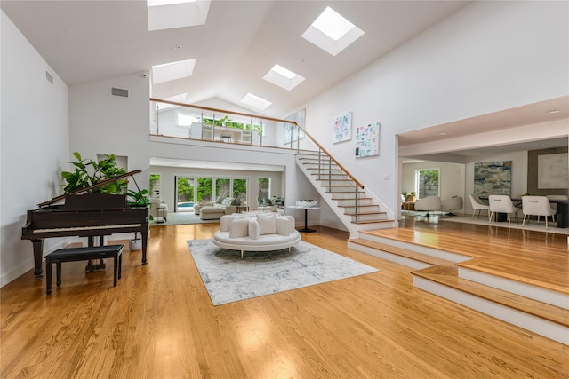 6005 Northwood Rd, Dallas, TX 75225 - foyer entrance with a skylight, visible vents, wood finished floors, and stairway
