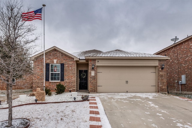 ranch-style home with a garage, concrete driveway, and brick siding