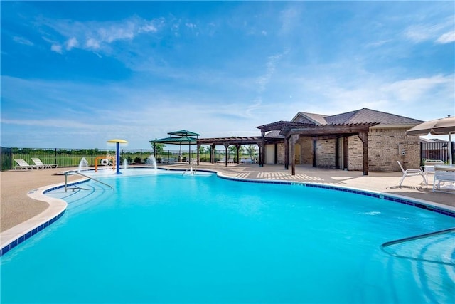 pool with a patio, fence, and a pergola