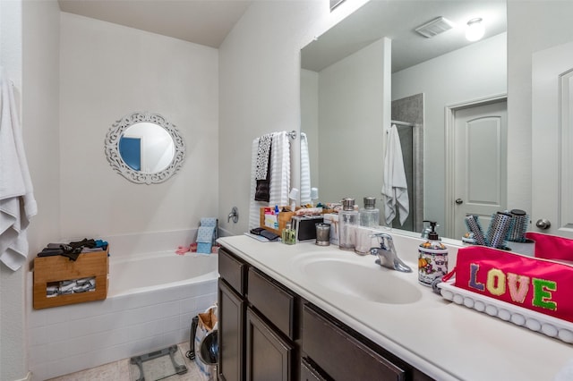 full bathroom with a garden tub, a shower stall, visible vents, and vanity