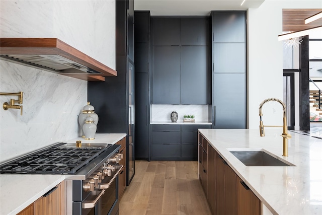 kitchen featuring tasteful backsplash, brown cabinetry, modern cabinets, double oven range, and a sink