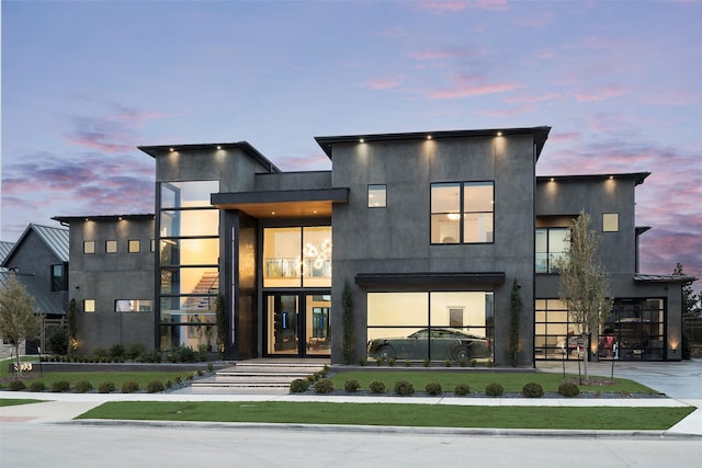 modern home featuring concrete driveway and stucco siding