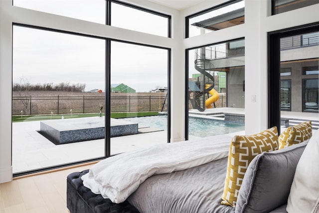 bedroom featuring multiple windows and wood finished floors