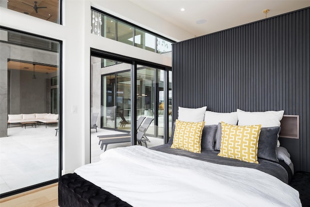 bedroom featuring wood finished floors and access to exterior