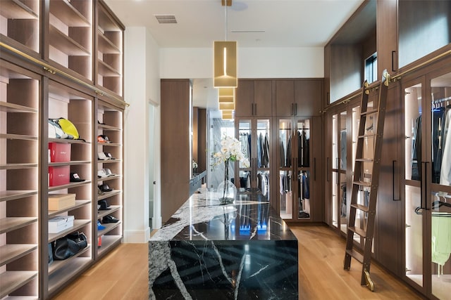 spacious closet featuring visible vents and light wood-style floors