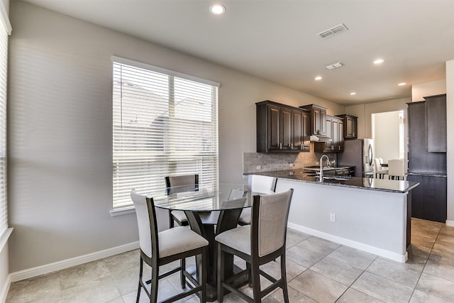 dining room with light tile patterned flooring, recessed lighting, visible vents, and baseboards